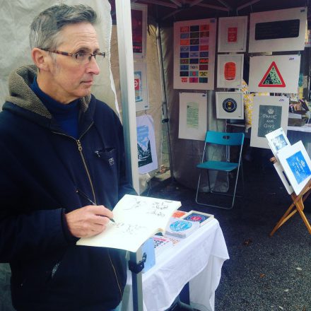 Local artist Martin Grover with his sketch book at Artisans' Market